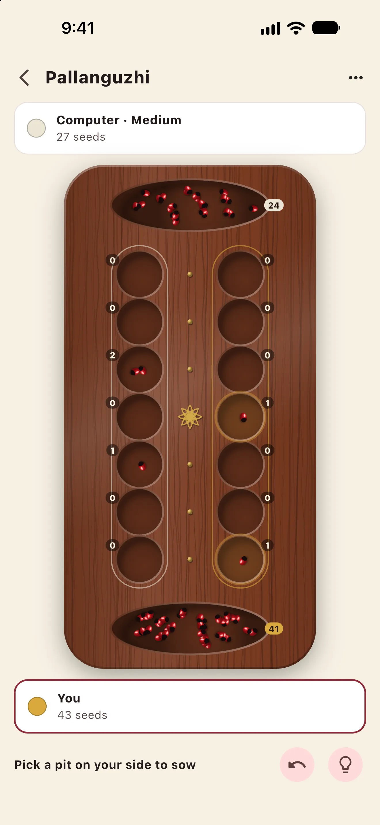 Imli Pallanguzhi: sowing seeds round the pits of a rosewood mancala board against the computer